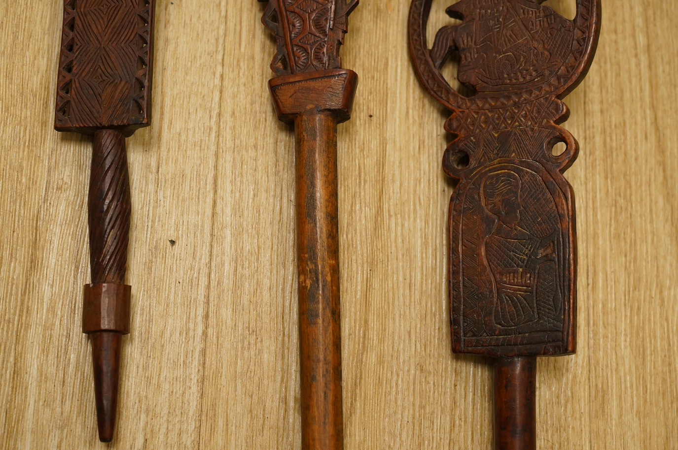 Three 19th century Russian or Eastern European treen distaffs, longest 77cm. Condition - fair to good, one with missing bottom section